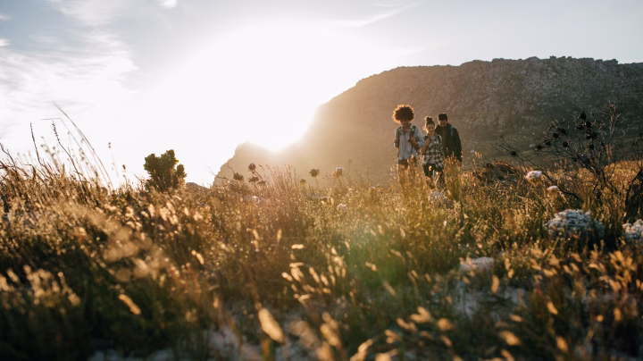 People walking through a natural landscape representing long-term ESG    impact.