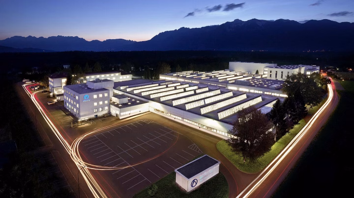Aerial night view of industrial facility showing sustainable transformation and    ESG impact.
