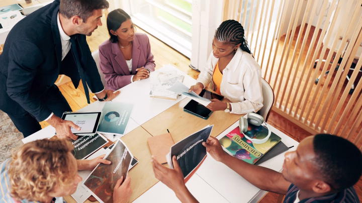 Co-workers in a modern workplace building a strategy.