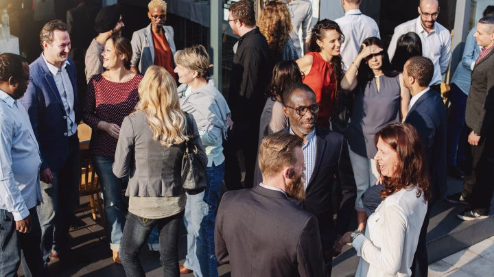 Group of diverse people talking, representing a responsible workplace culture.